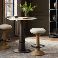 Antwerp Natural counter stool with a plush seat and curved wooden base.