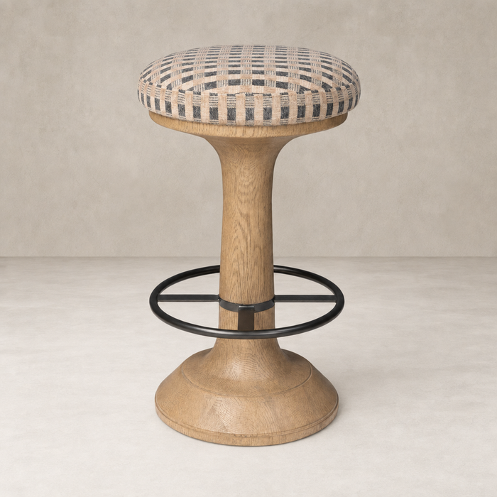 Firefinch Fawn counter stool with a padded checkered seat and wooden base.