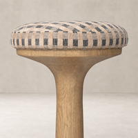 Counter stool with a patterned cushion and light wooden base in Firefinch Fawn.