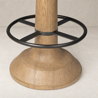 Counter stool in Firefinch Fawn, featuring a wood finish and black metal footrest.