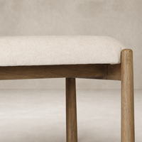 Seoul Bar + Counter Stool in Lynchart Sand with soft upholstery and natural wood legs.