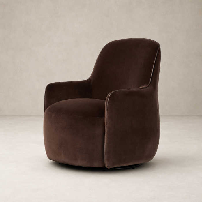 Paloma Swivel Chair in Surrey Cocoa, featuring soft curves and plush fabric.