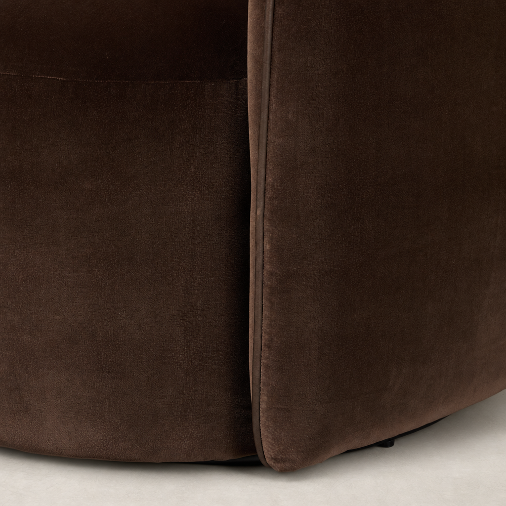 Close-up of Paloma Swivel Chair in Surrey Cocoa, showcasing soft velvet texture and rounded edges.