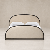Curved bed in Savoy Parchment fabric with black metal accents.