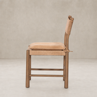 Side view of a Winchester Beige dining chair with a cushioned seat and wooden frame.