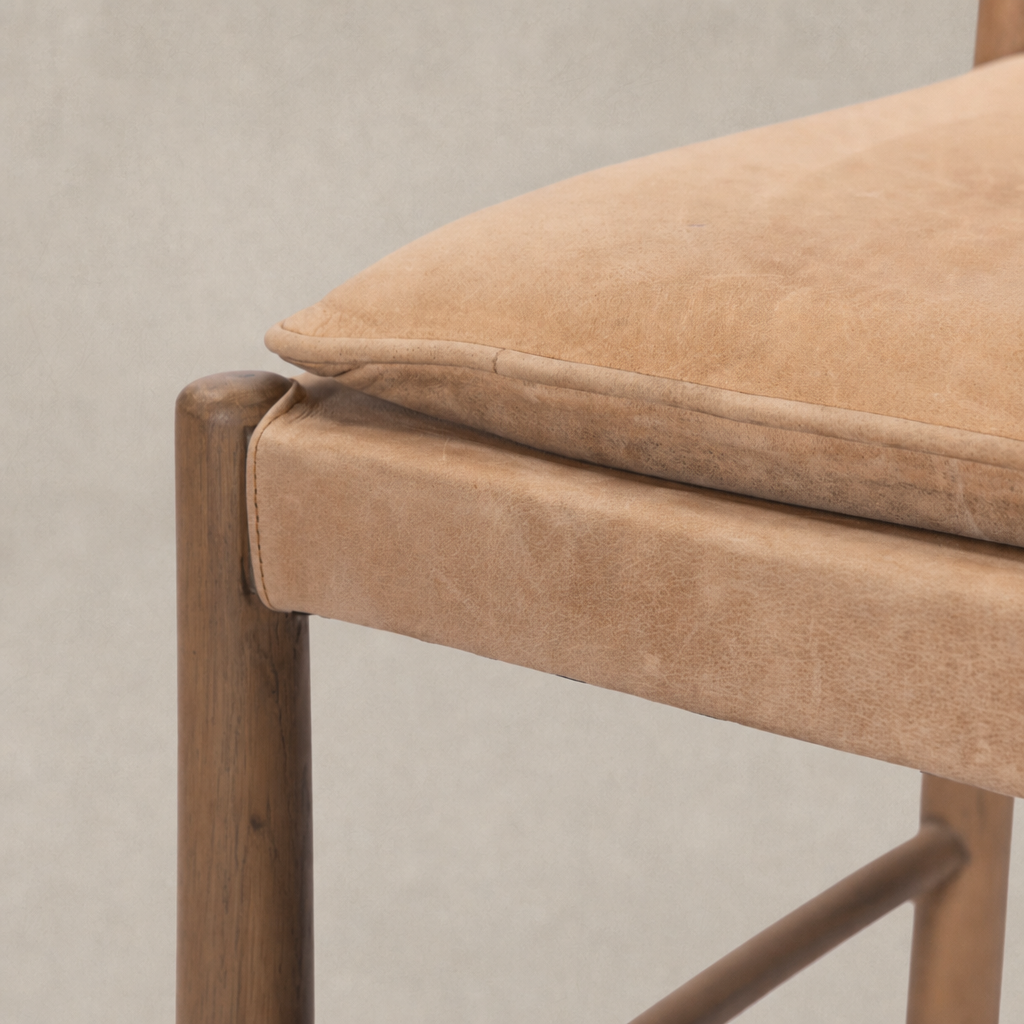 Close-up of a Winchester Beige dining chair with padded seat and wooden frame.