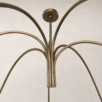 Aged antique brass iron chandelier with elegant curved arms and sleek finish.