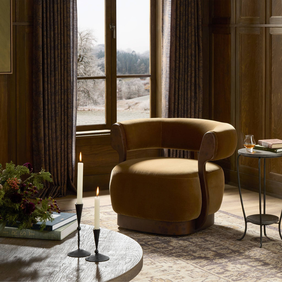 Bodhi Swivel Chair in Surrey Ochre, featuring a rounded shape and soft upholstery.