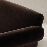 Serena Chair in Monte Chocolate featuring a soft, textured upholstery and curved armrest.