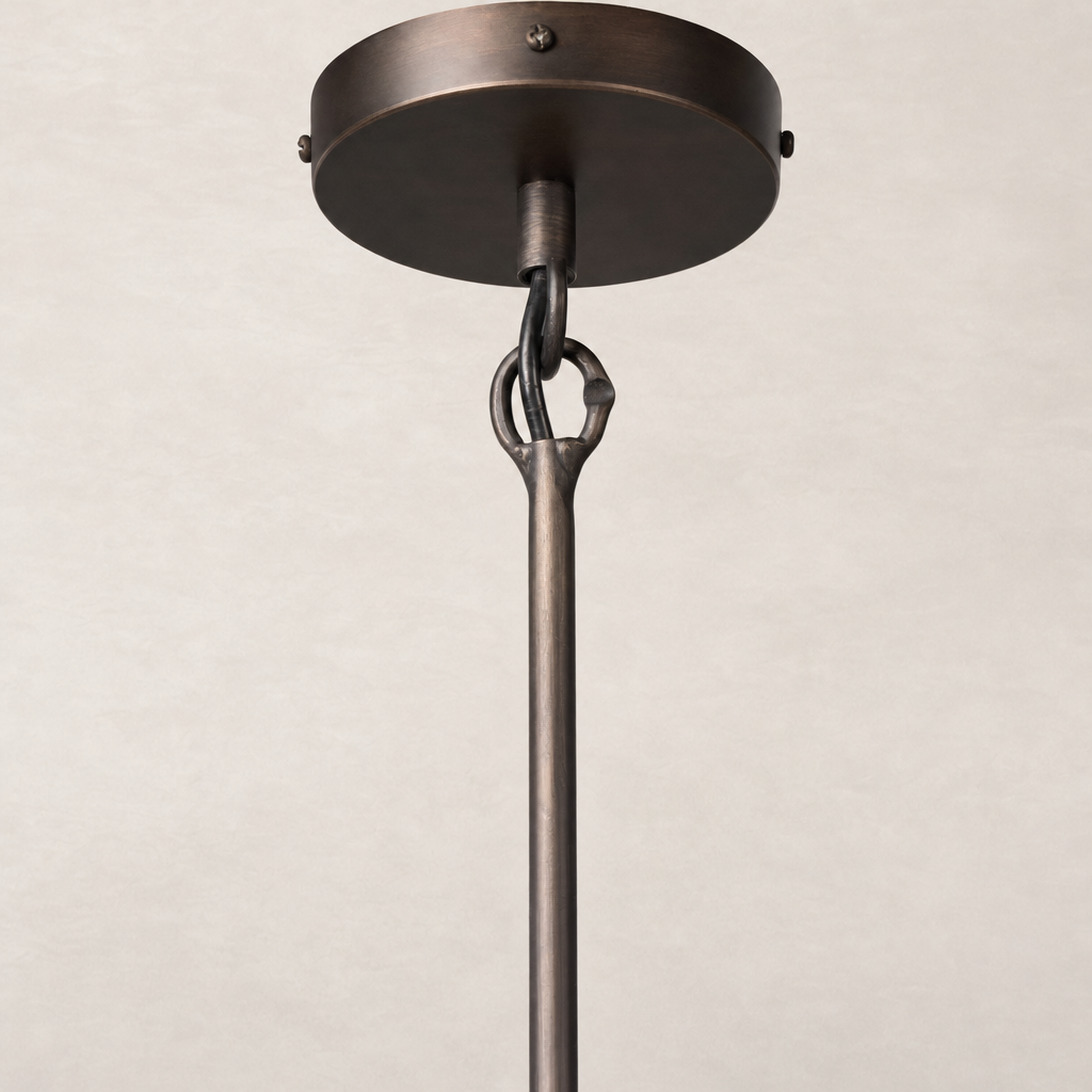 Amber glass pendant light with a sleek, modern design and matte bronze finish.