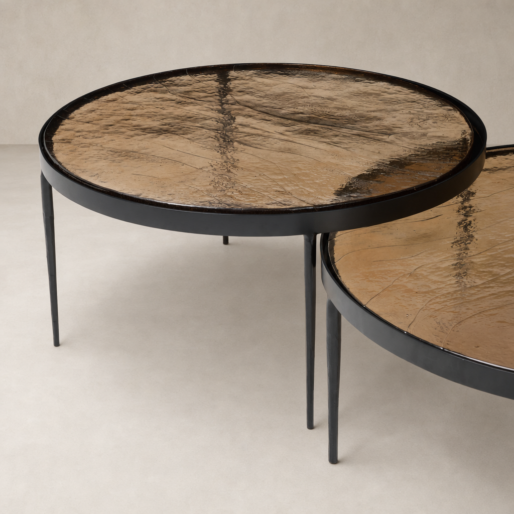 Kiko Nesting Tables in smoked brown cast glass with round tops and slender black legs.