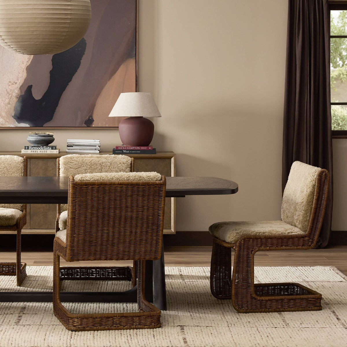 Ingrid Dining Chair in beige shorn shearling with stylish woven frame in modern dining setting.