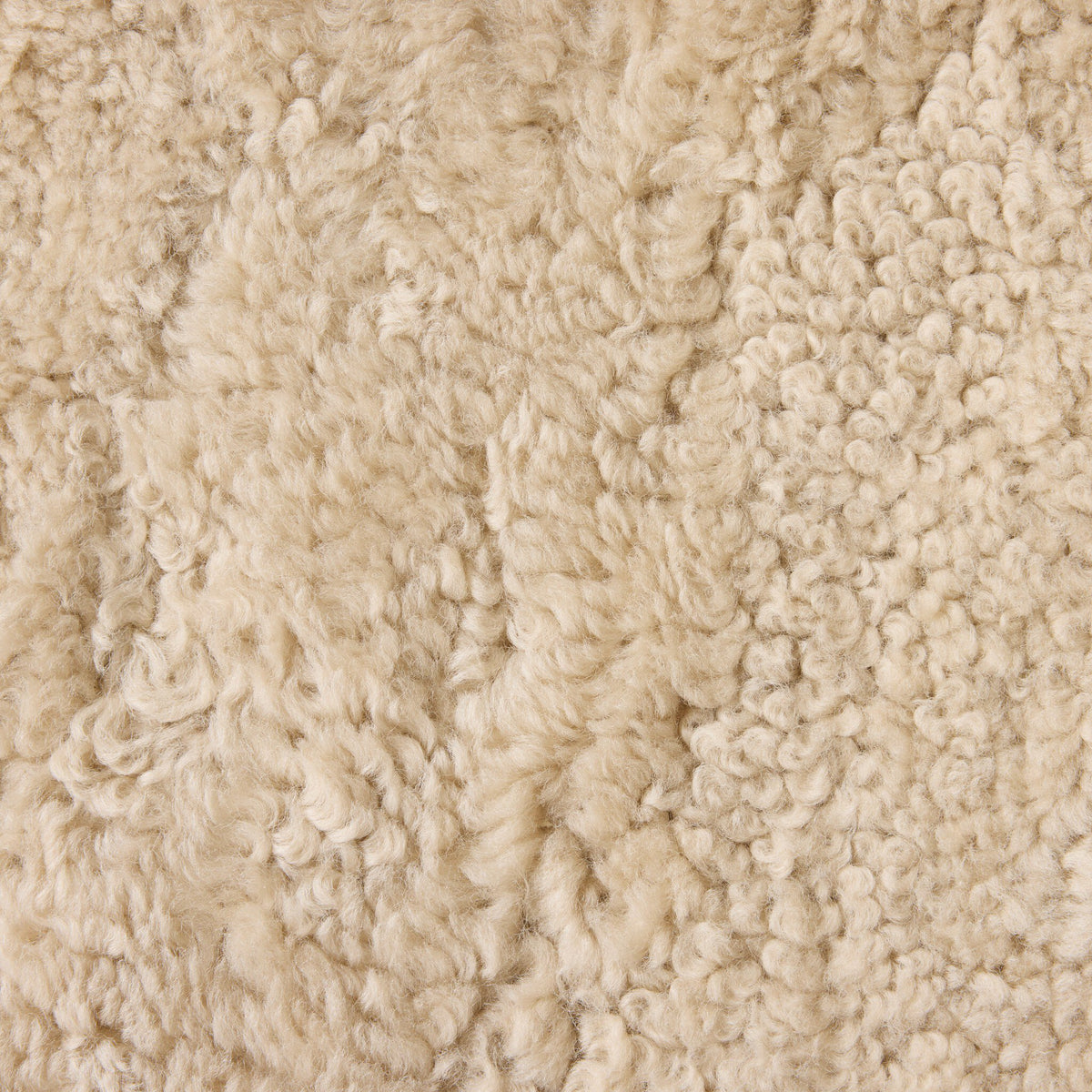 Close-up of beige shorn shearling texture from the Ingrid Dining Chair.