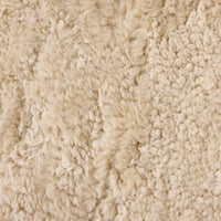 Close-up of beige shorn shearling texture from the Ingrid Dining Chair.