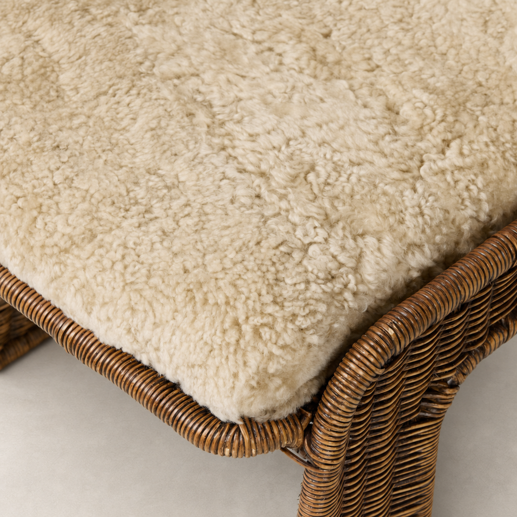 Beige shorn shearling cushion on the Ingrid Dining Chair's woven base.