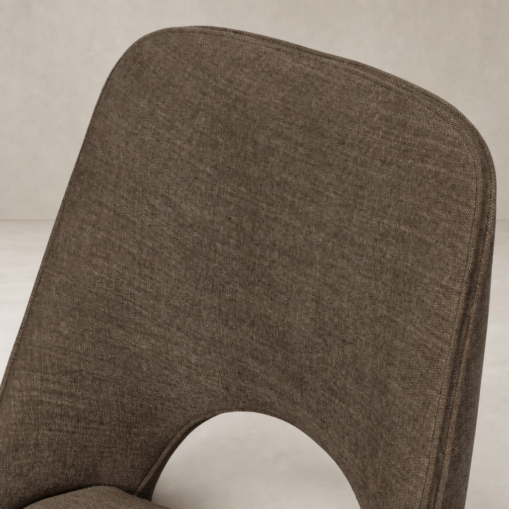 Close-up of Huxley Dining Chair in Laughlin Cafe fabric, highlighting the textured upholstery.