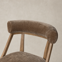 Altair Mushroom dining chair with a curved velvet backrest and wooden legs.