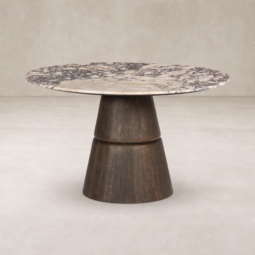 Round dining table featuring Calacatta Viola marble top and a unique wooden base.