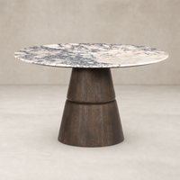Round dining table featuring a stunning Calacatta Viola marble top and a sculptural wooden base.