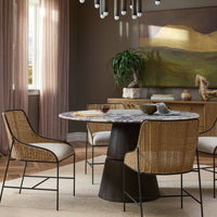 Calacatta Viola Marble dining table with a sculptural wooden base and stylish chairs.