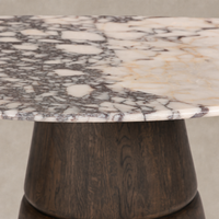 Calacatta Viola marble dining table with a sleek, modern design and a dark wood base.