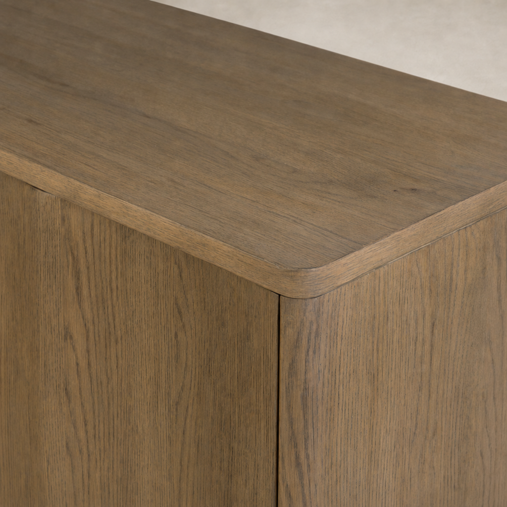 Felix Small Cabinet in drifted oak featuring a smooth, rounded top and wood grain texture.
