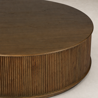 Round Ola Coffee Table in amber mindi featuring fluted wood detailing.