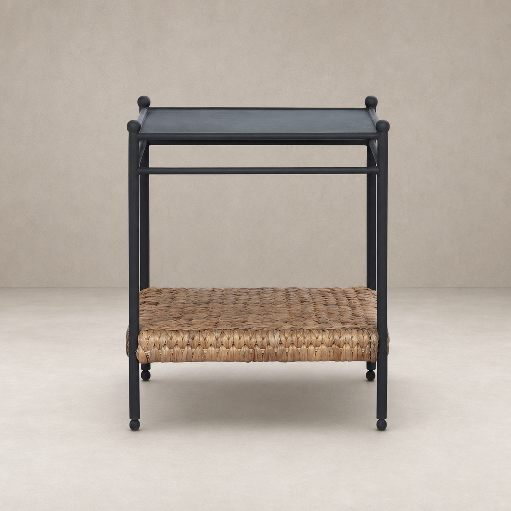 Colette End Table with a sleek black frame and woven natural fiber shelf.