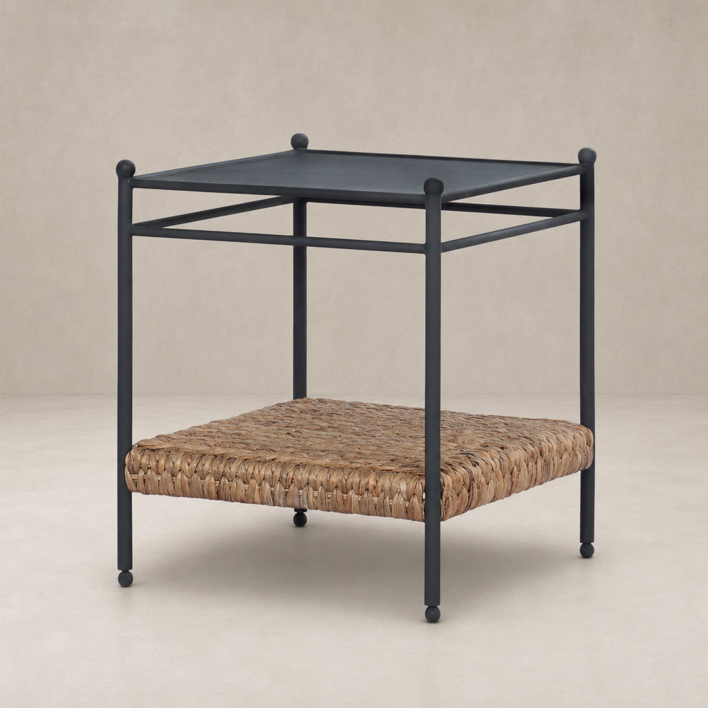 Colette End Table features a black metal frame with a woven rattan shelf.