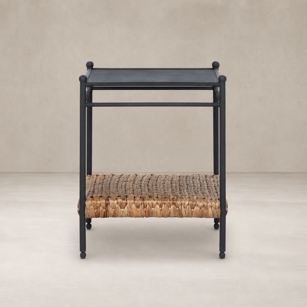 Colette End Table with a sleek black frame and natural woven storage shelf.