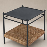 Colette End Table in black metal with a woven rattan lower shelf.
