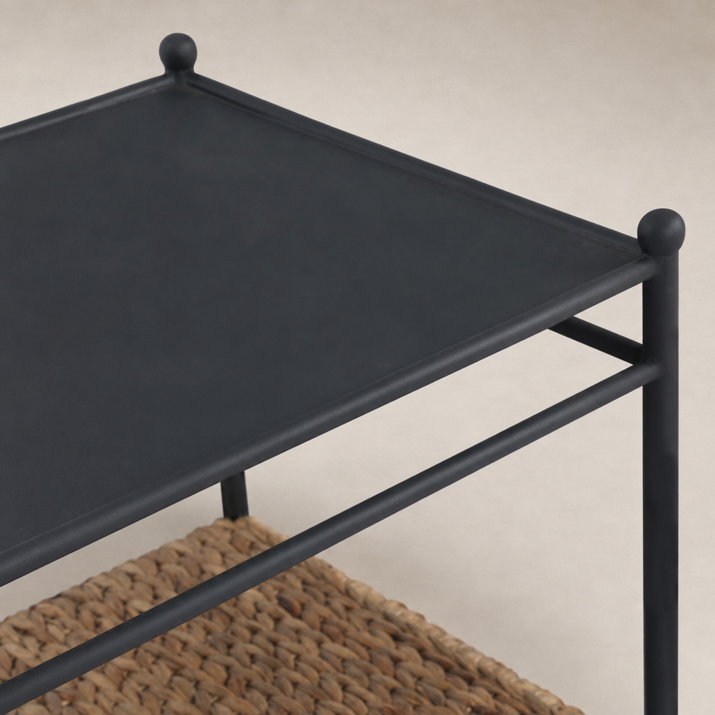 Colette End Table featuring a sleek black metal top and woven storage shelf.