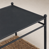 Colette End Table featuring a sleek black metal top and woven storage shelf.