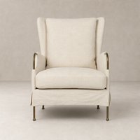 Ada Chair in Bergamo Parchment features a cozy high-back design with elegant brass accents.