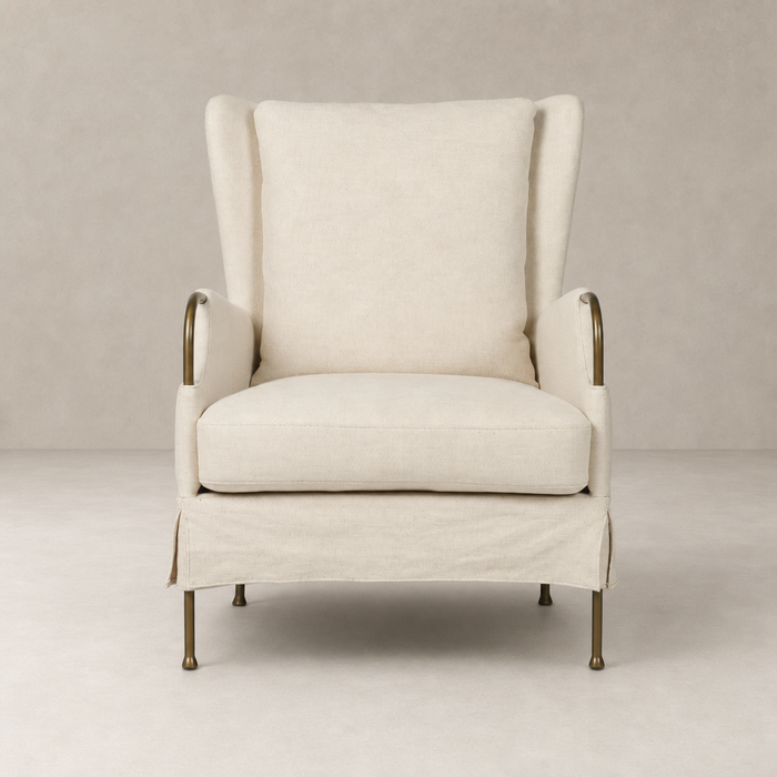 Ada Chair in Bergamo Parchment features a cozy high-back design with elegant brass accents.