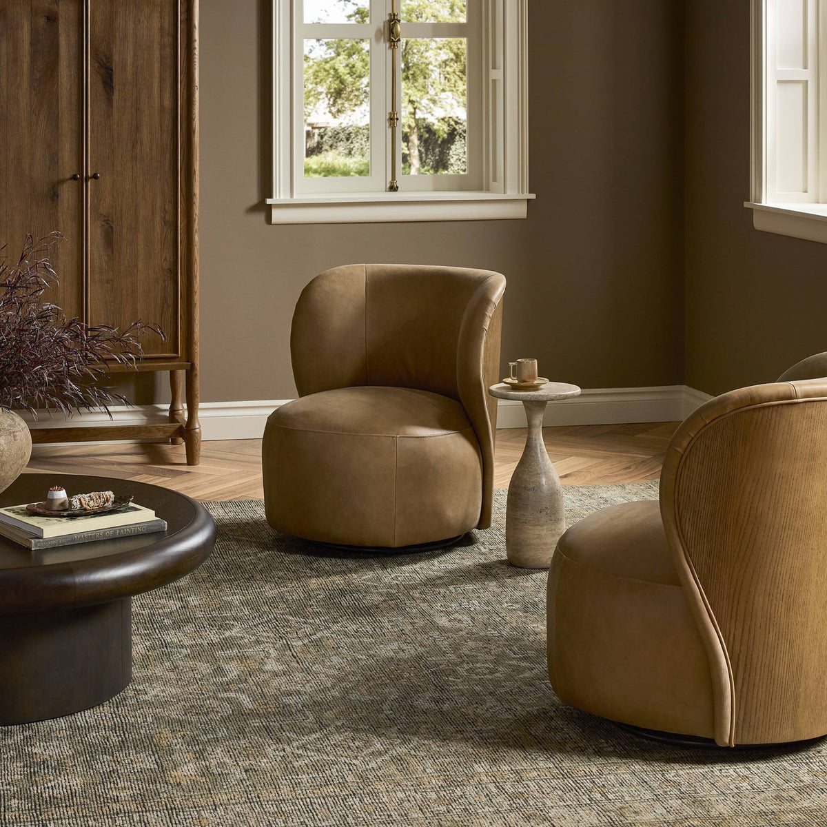 Misha Swivel Chair in Palermo Drift featuring a curved design and soft leather upholstery.