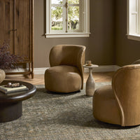 Misha Swivel Chair in Palermo Drift featuring a curved design and soft leather upholstery.