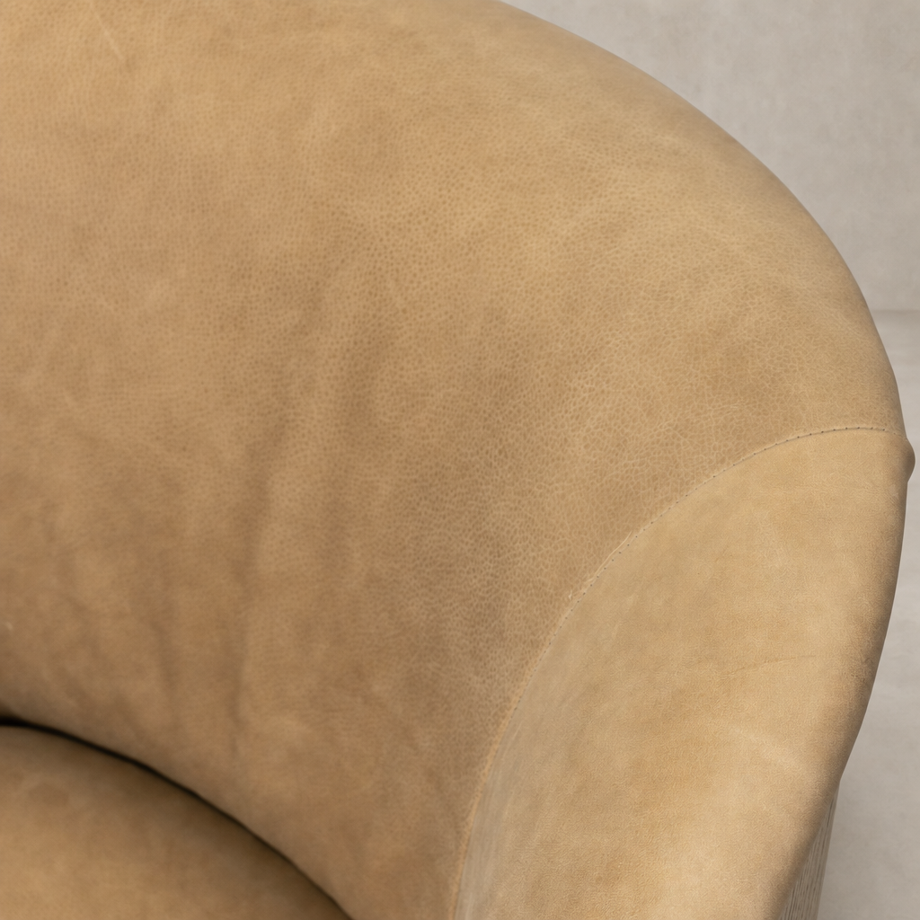 Close-up of the Misha Swivel Chair in Palermo Drift showcasing its soft texture and elegant curves.