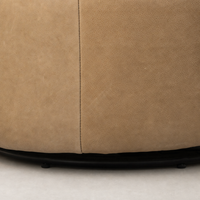 Misha Swivel Chair in Palermo Drift shows textured, soft leather detailing and sleek black base.