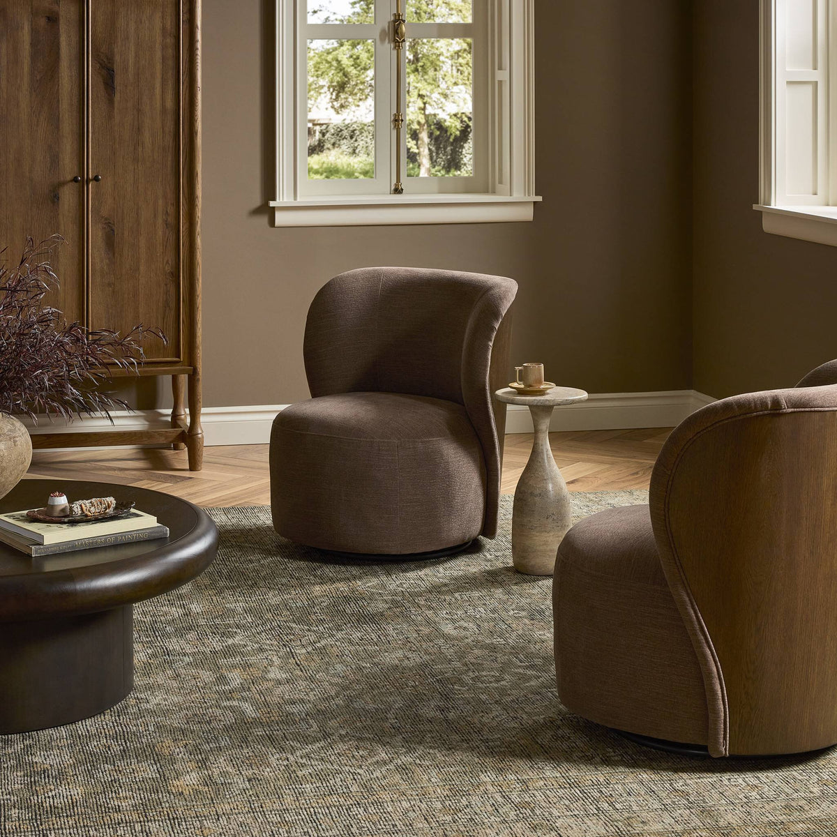 Misha Swivel Chair in Laughlin Cafe, featuring a curved design and plush upholstery.