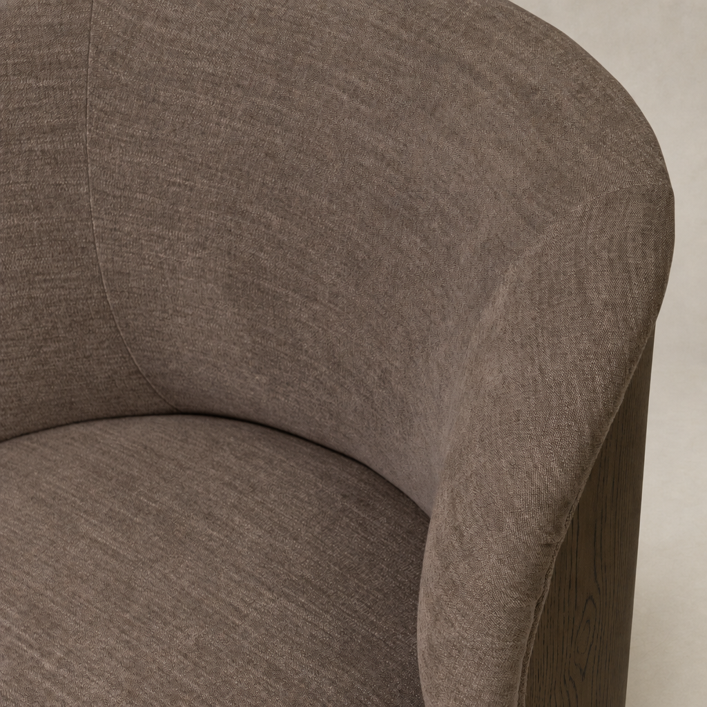 Close-up of Misha Swivel Chair in Laughlin Cafe, showcasing soft, textured upholstery and curved design.