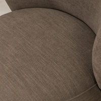 Close-up of Misha Swivel Chair in Laughlin Cafe showing soft, textured upholstery.