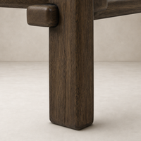 Close-up of the Marin Square Marble Coffee Table's rich brown Emperador marble and sturdy wooden leg.