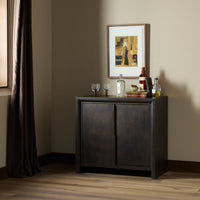 Espresso Oak Lazuli Small Cabinet in stylish room setting with decorative items.