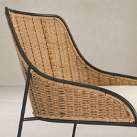 Savile Flax dining chair with curved woven seat and sleek black metal frame.