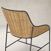 Savile Flax dining chair featuring a woven back and sleek black metal frame.