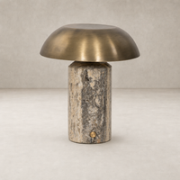 Cordless table lamp in aged antique brass iron with a cylindrical base.