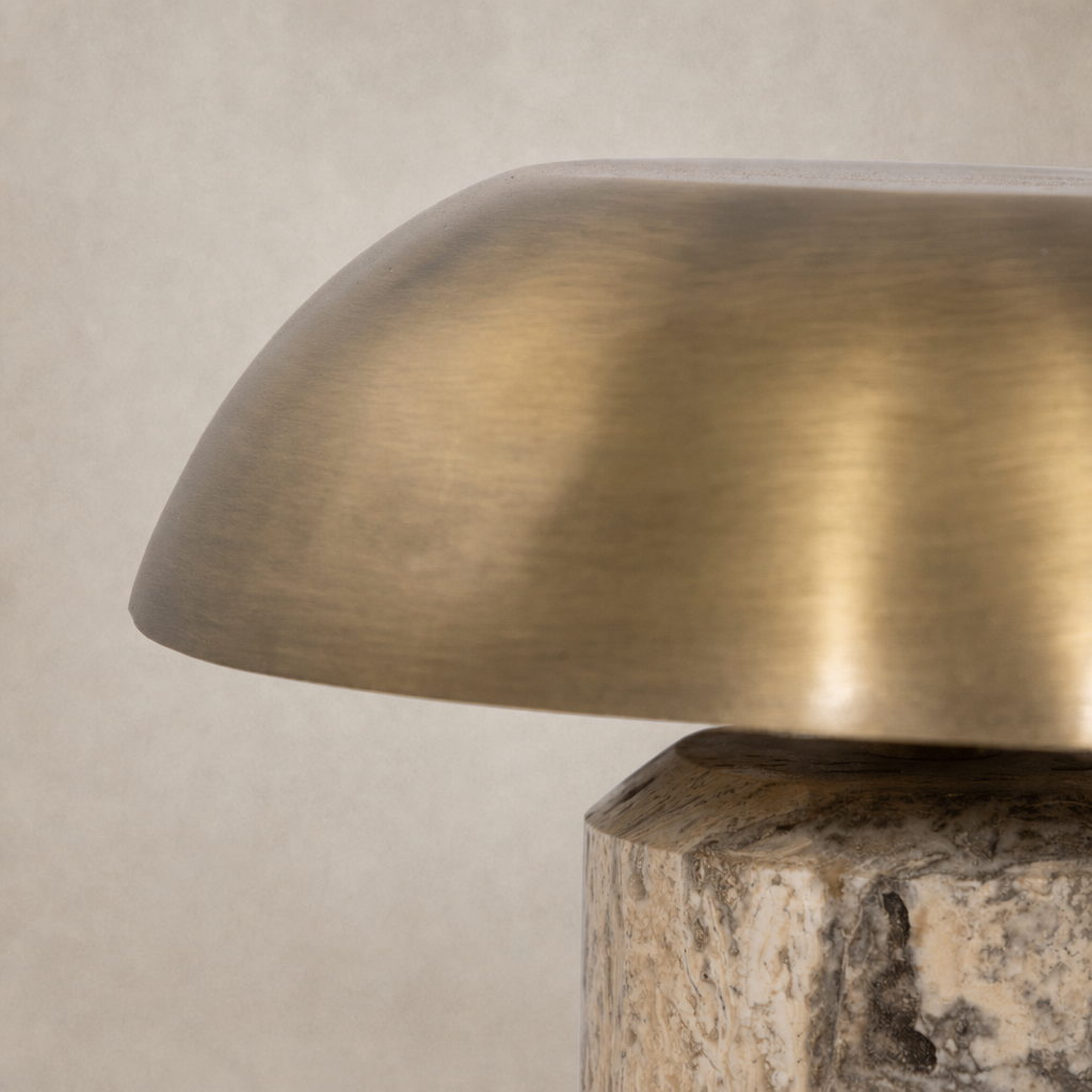 Cordless table lamp with a smooth aged antique brass finish and textured base.