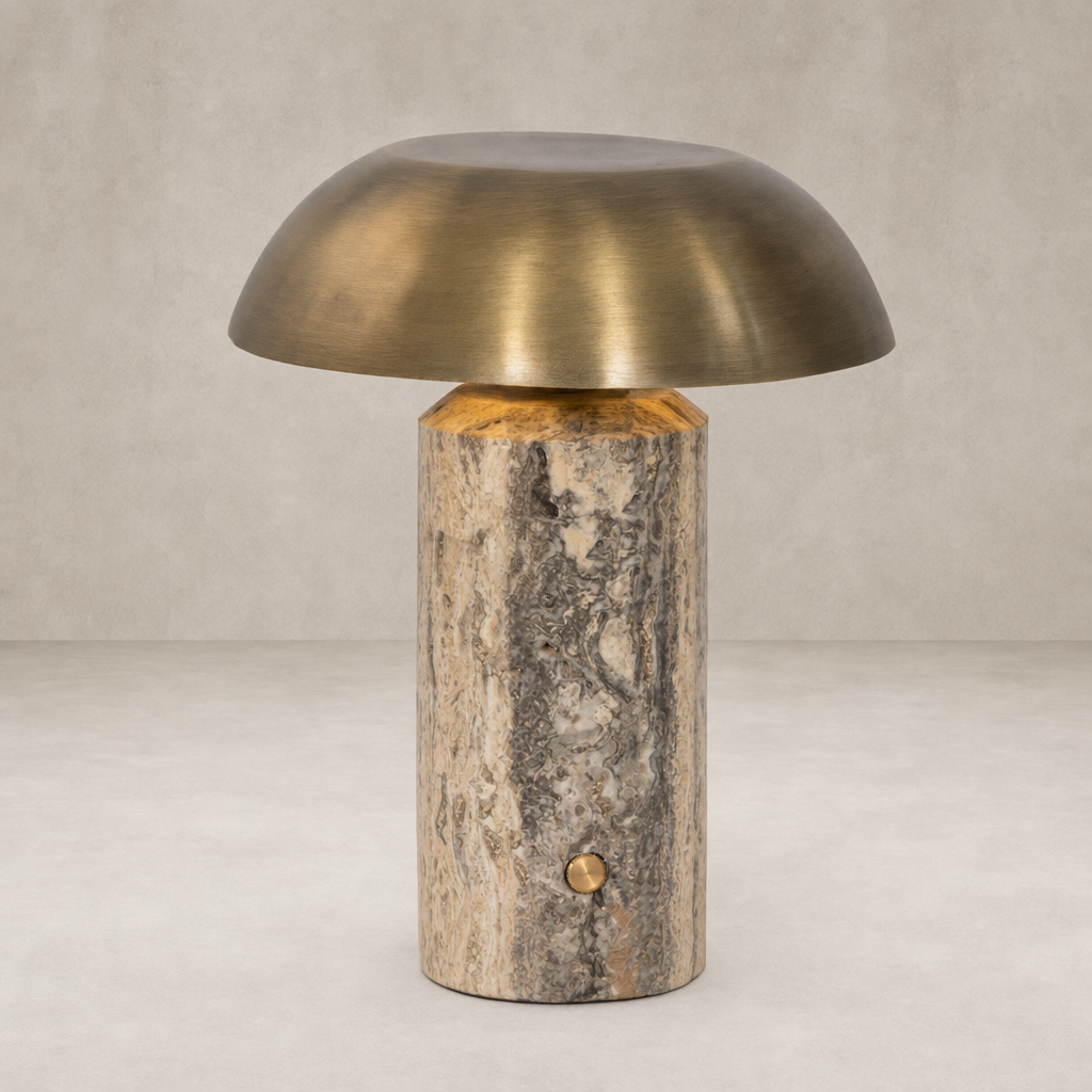 Cordless table lamp with aged antique brass finish and textured iron base.