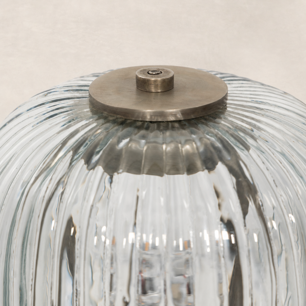 Antique nickel cordless table lamp with a ribbed glass shade top.
